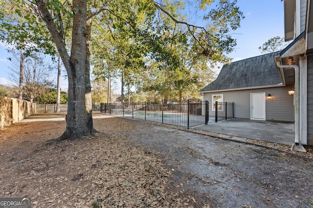 view of yard featuring a fenced in pool and a patio