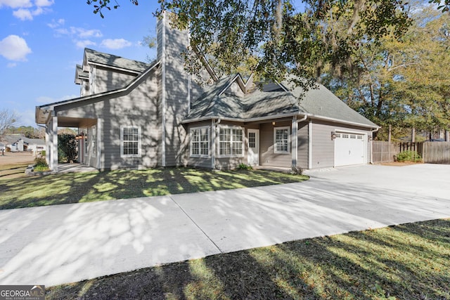 front facade featuring a garage and a front lawn