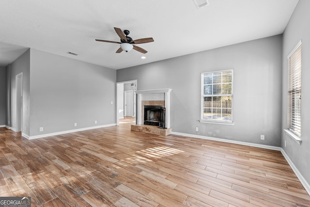 unfurnished living room with ceiling fan and light hardwood / wood-style floors