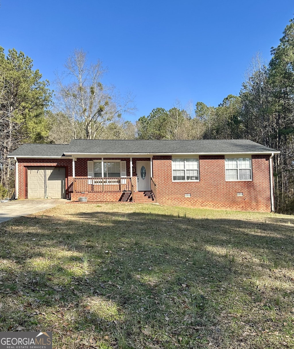 480 Skinners Byp, Milner, GA 30257 - ranch-style house with covered porch, an attached garage, brick siding, and a front lawn