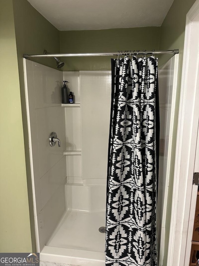 full bathroom with a shower stall