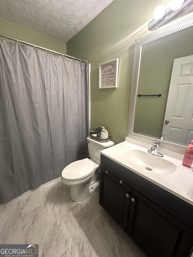 full bathroom featuring a textured ceiling, toilet, a shower with shower curtain, vanity, and marble finish floor