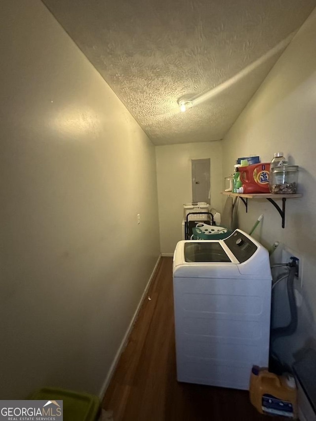 laundry room with laundry area, electric panel, baseboards, wood finished floors, and a textured ceiling