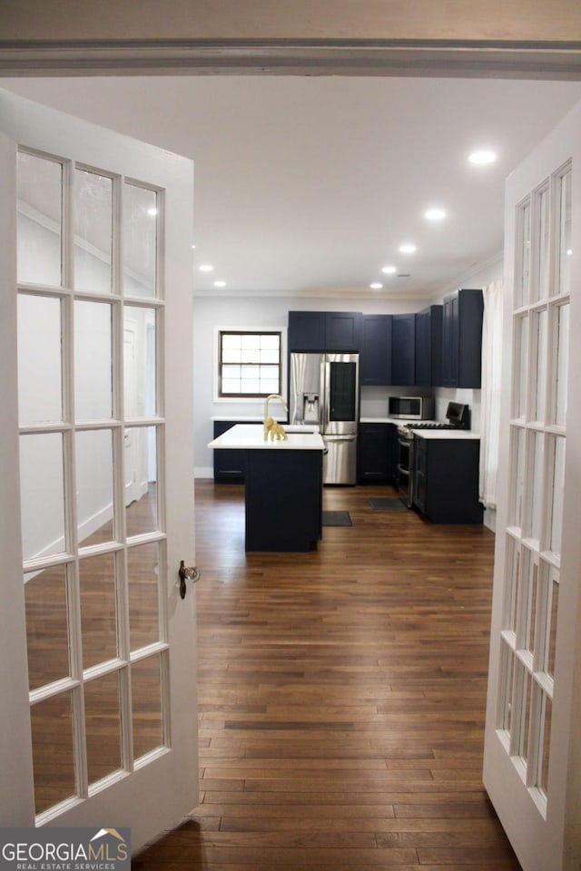 kitchen featuring french doors, stainless steel appliances, dark hardwood / wood-style flooring, and a kitchen island