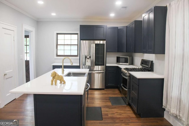 kitchen with sink, crown molding, dark hardwood / wood-style floors, stainless steel appliances, and a kitchen island with sink