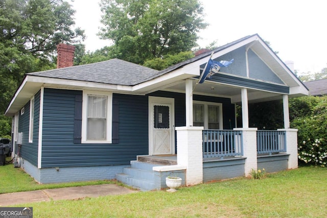 bungalow-style home featuring a porch and a front yard