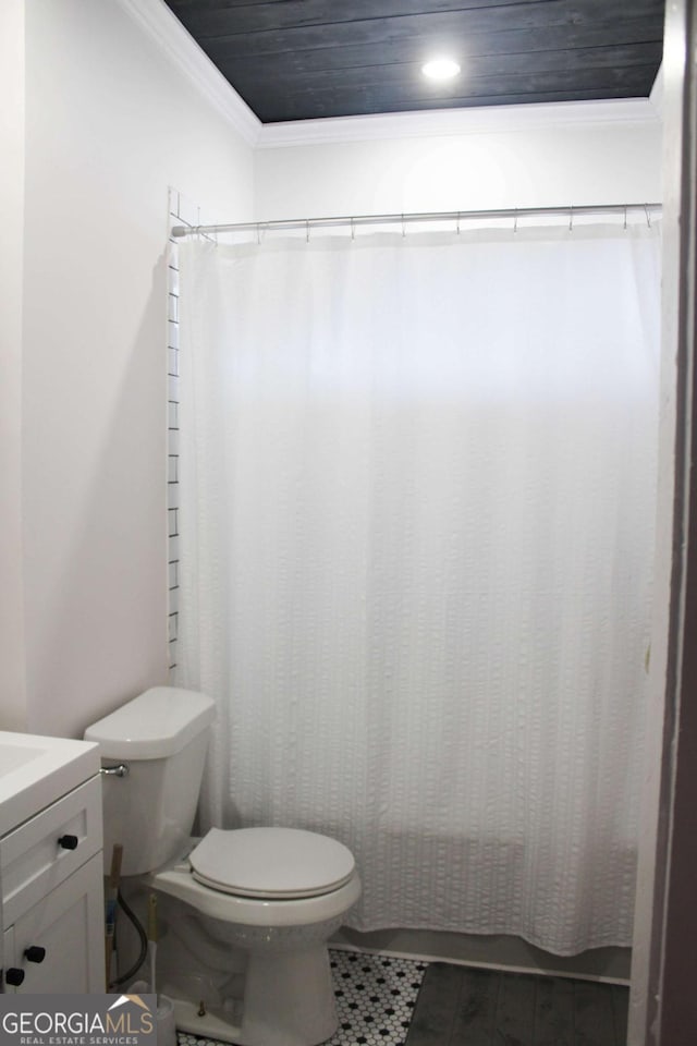 bathroom with toilet, a shower with curtain, ornamental molding, vanity, and tile patterned flooring