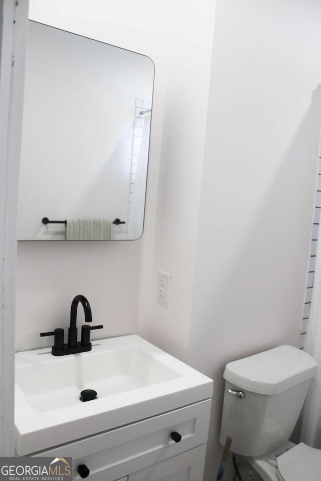 bathroom featuring vanity and toilet