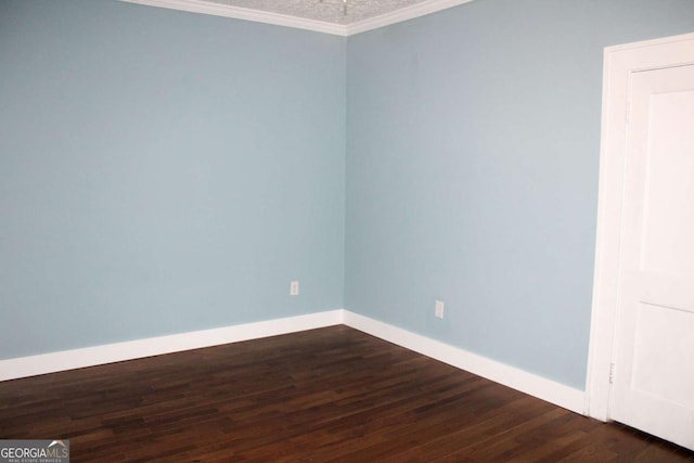 unfurnished room featuring dark wood-type flooring and ornamental molding