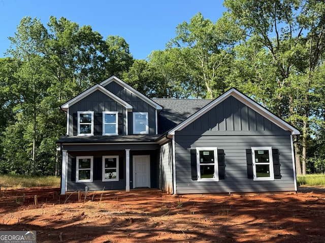 148 Asa Moseley Rd, Mcdonough, GA 30252 - view of front of house featuring board and batten siding, a shingled roof, and a porch