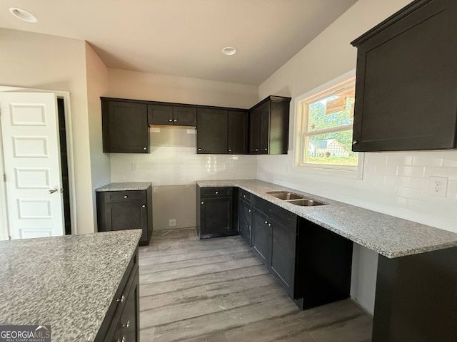148 Asa Moseley Rd, Mcdonough, GA 30252 - kitchen with decorative backsplash, light wood-style flooring, a sink, and dark brown cabinets