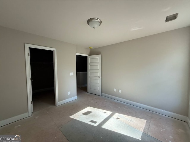 148 Asa Moseley Rd, Mcdonough, GA 30252 - unfurnished bedroom with a walk in closet, a closet, and baseboards