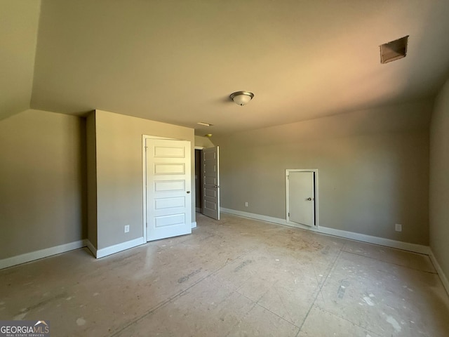 148 Asa Moseley Rd, Mcdonough, GA 30252 - unfurnished bedroom featuring vaulted ceiling and baseboards