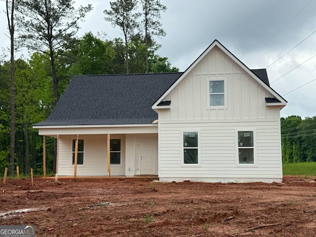 view of front of home featuring roof with shingles, covered porch, and board and batten siding