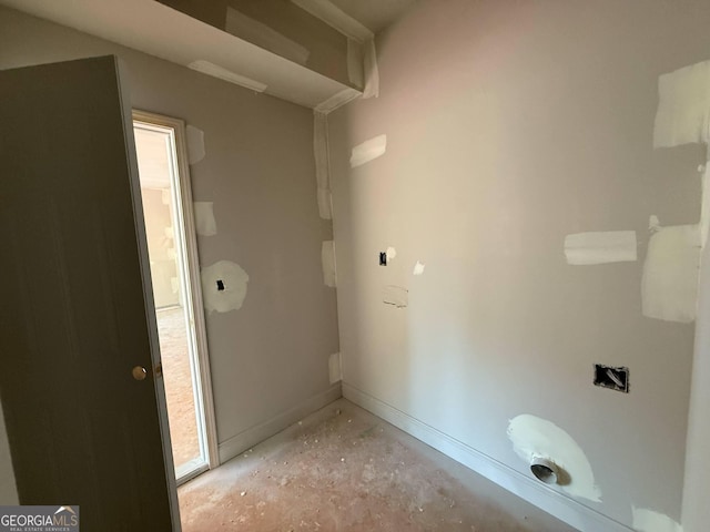 bathroom featuring baseboards and concrete flooring