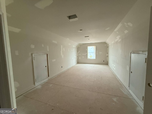 interior space with baseboards and lofted ceiling