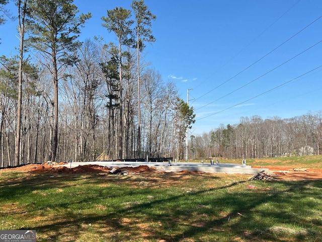 view of yard with a view of trees