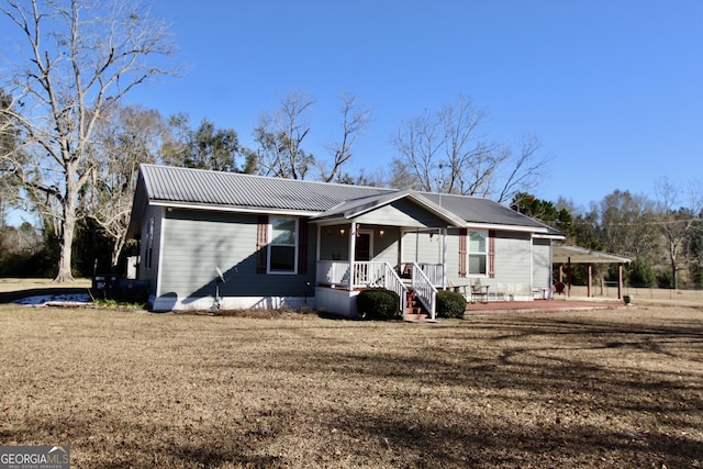 ranch-style home with covered porch and a front yard