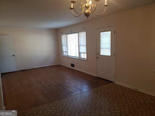 foyer featuring dark hardwood / wood-style floors and a notable chandelier