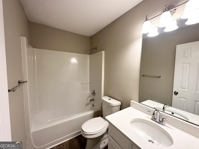 full bathroom with toilet, shower / bathing tub combination, a textured ceiling, vanity, and hardwood / wood-style flooring