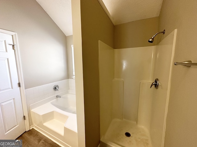 bathroom with lofted ceiling, wood-type flooring, plus walk in shower, and a textured ceiling