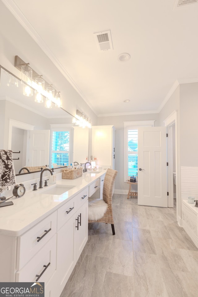 bathroom featuring vanity, ornamental molding, and a bath