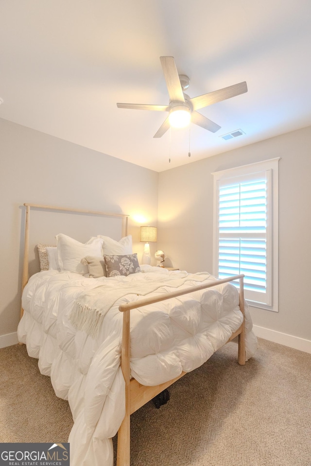 bedroom featuring ceiling fan and carpet