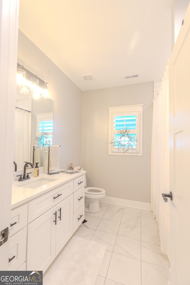 bathroom featuring vanity and toilet