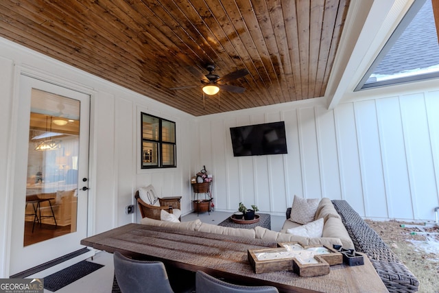 living room with beam ceiling, wooden ceiling, and ceiling fan