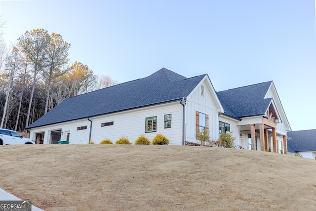 view of property exterior with a garage and a lawn