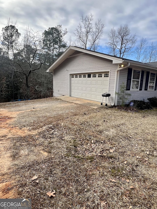 view of side of property with a garage