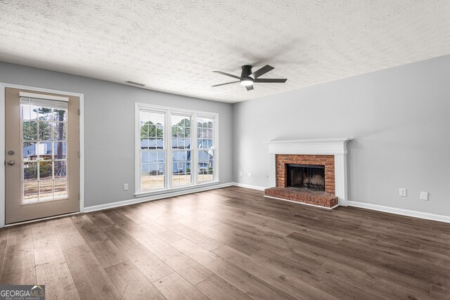 interior space with hardwood / wood-style floors, crown molding, a wealth of natural light, and a textured ceiling