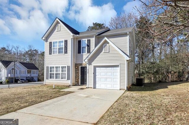 view of property with a garage, cooling unit, and a front lawn