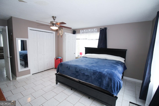 tiled bedroom featuring ceiling fan and a closet