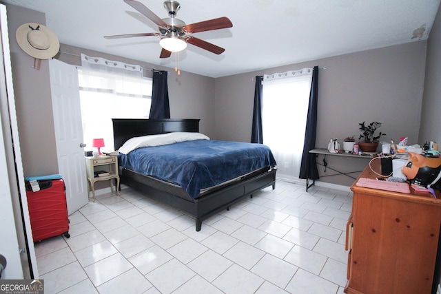 bedroom featuring light tile patterned flooring and ceiling fan