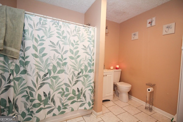 bathroom with tile patterned flooring, vanity, a textured ceiling, toilet, and walk in shower