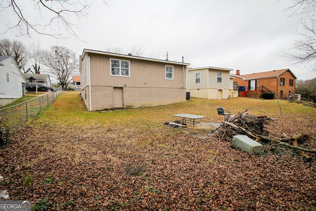 back of property with a patio and a lawn