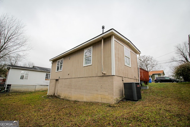 view of property exterior with a yard and central AC unit