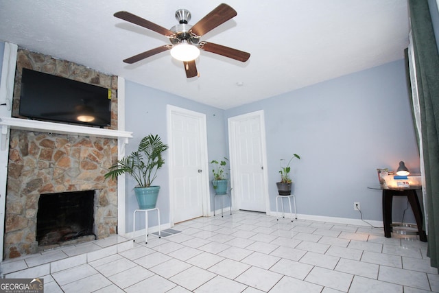 unfurnished living room with light tile patterned flooring, ceiling fan, and a fireplace