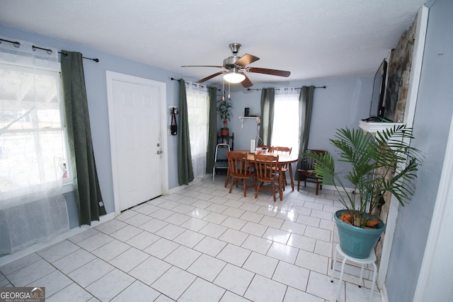 tiled dining area with ceiling fan