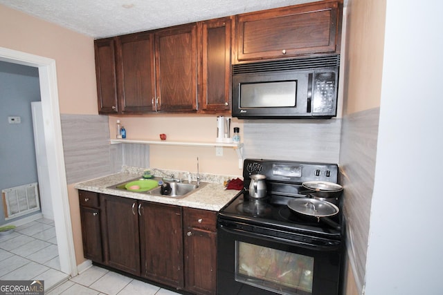 kitchen featuring sink, dark brown cabinetry, black appliances, a textured ceiling, and light tile patterned flooring