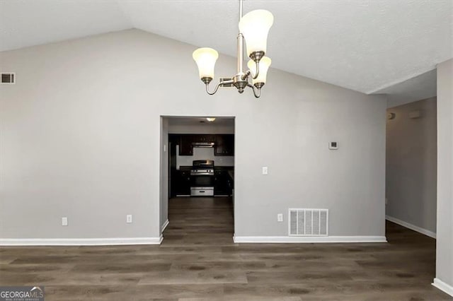 unfurnished dining area with lofted ceiling, dark hardwood / wood-style floors, and a notable chandelier