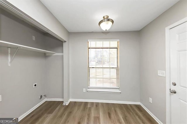 washroom featuring dark wood-type flooring and hookup for an electric dryer