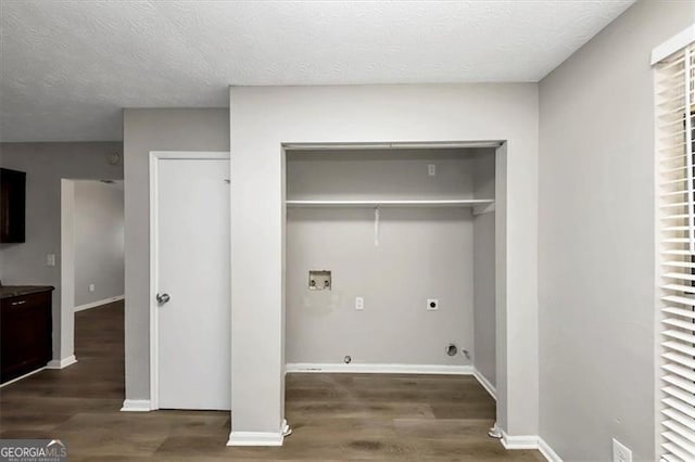 clothes washing area featuring hookup for an electric dryer, dark hardwood / wood-style flooring, hookup for a washing machine, and a textured ceiling