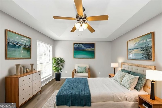 bedroom featuring hardwood / wood-style floors and ceiling fan