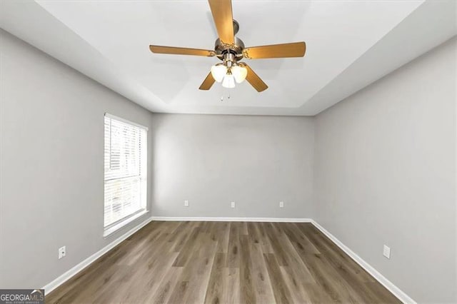 empty room featuring wood-type flooring and ceiling fan