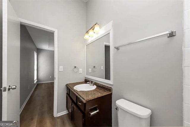 bathroom featuring hardwood / wood-style flooring, vanity, and toilet