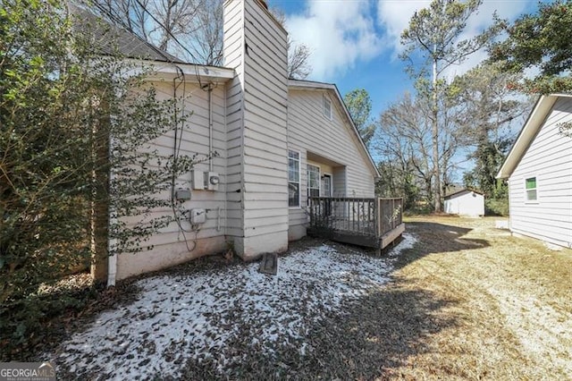 view of side of home with a wooden deck