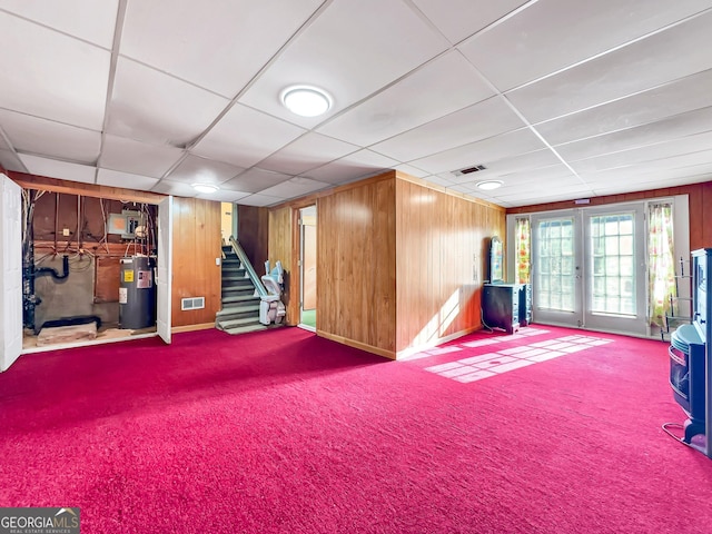 rec room featuring french doors, carpet floors, water heater, and wood walls