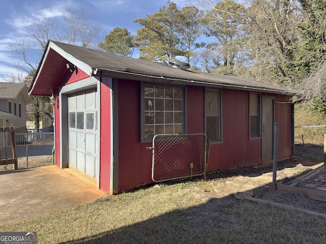 view of property exterior featuring a garage and an outdoor structure